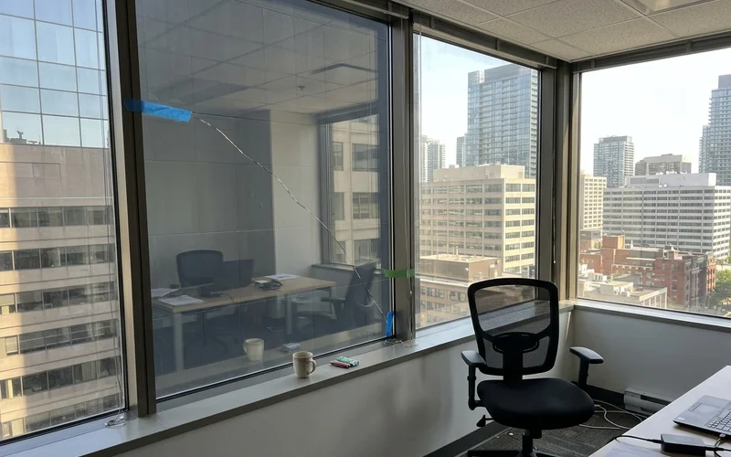Thermal stress crack across a tinted office vision lite from inside