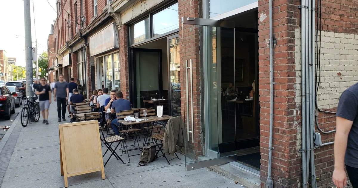 New frameless tempered pivot entrance door on a Queen West restaurant