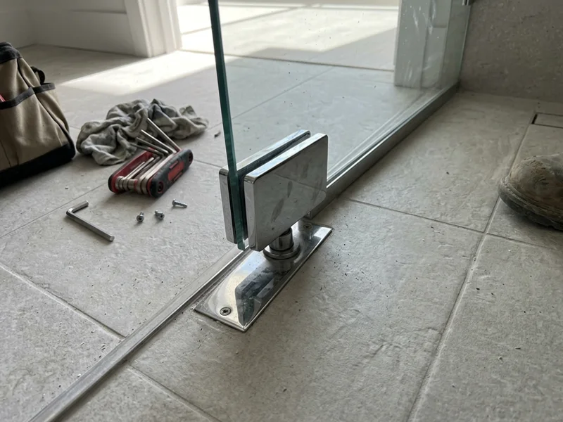 Patch fitting and Dorma floor closer on a new frameless glass door