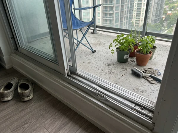 Damaged aluminium sliding door track on a condo balcony