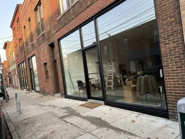 Finished floor-to-ceiling storefront glass on a King West boutique