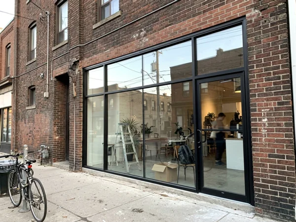 Finished tempered storefront glass on a King West shop