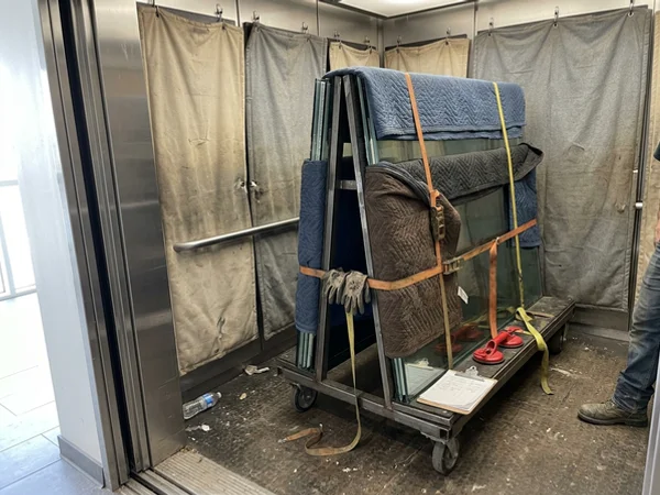New sealed units on an A-frame cart in a condo service elevator