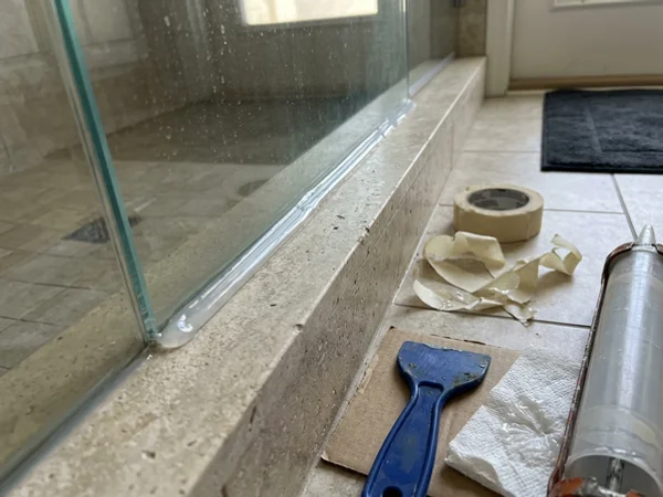 Fresh Dow Corning 795 bead at the base of a shower panel