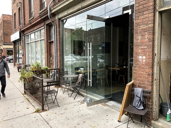 New frameless tempered pivot door on a Queen West restaurant