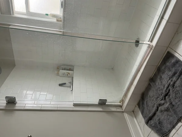 Sagging frameless shower door rubbing the tile in Rosedale