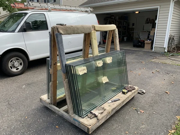 Stack of new double-pane units labelled by window location