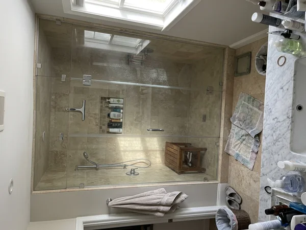 Steam shower enclosure with transom panel in a Mill Pond home