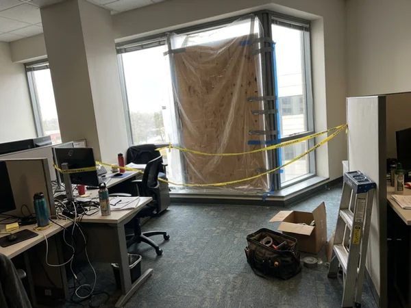Temporary protection installed over a broken office window bay