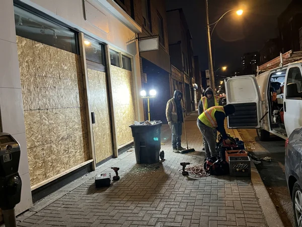 Yorkville boutique storefront boarded with 15mm OSB after a break-in